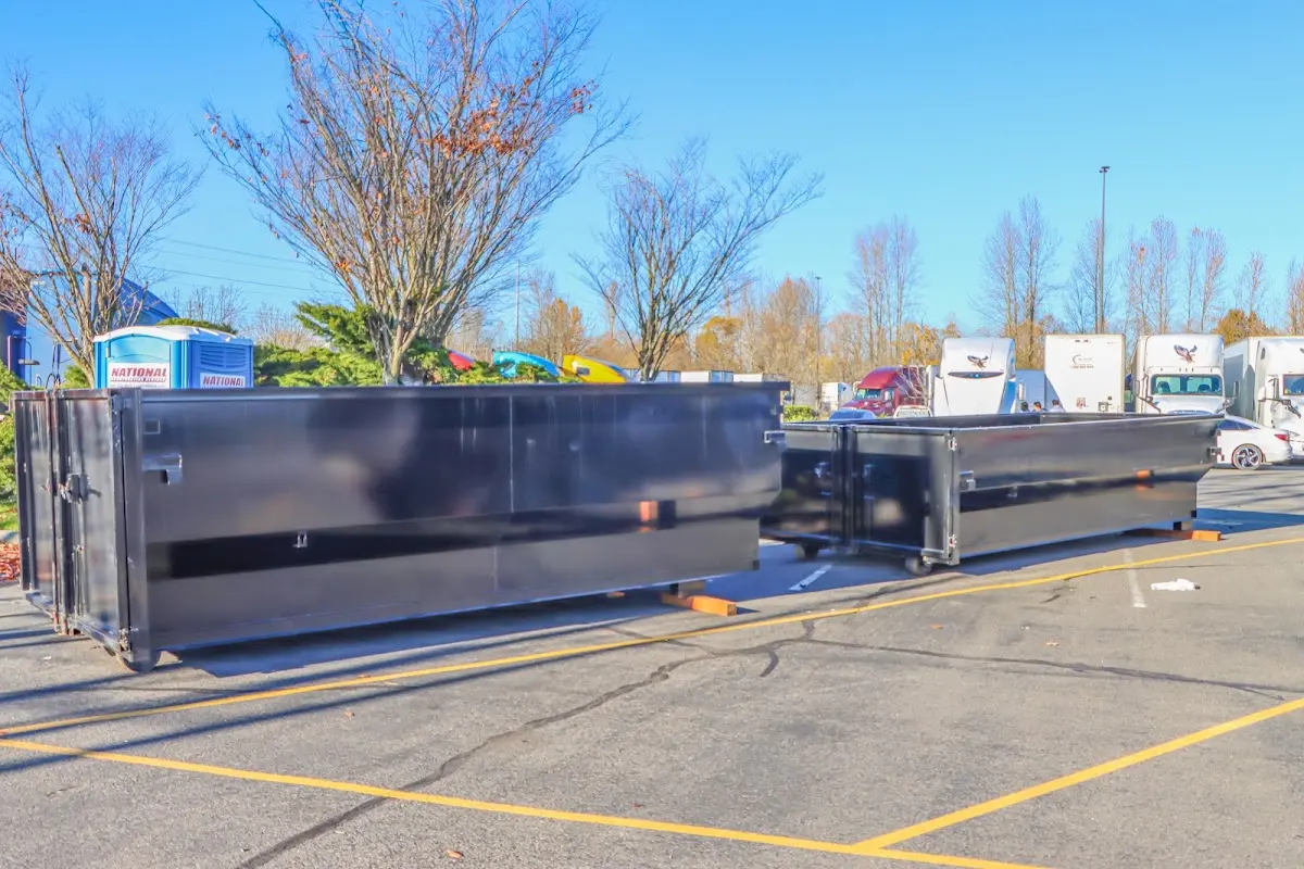 Professional dumpster rental service with roll-off container on residential driveway in Coolidge